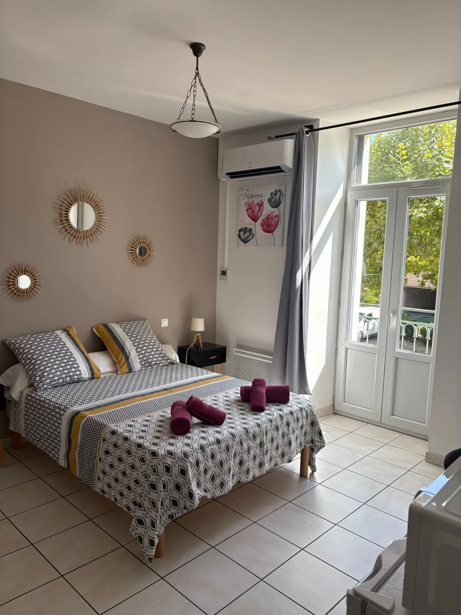 Chambre 3 : lit double et porte-fenêtre ouverte sur le balcon